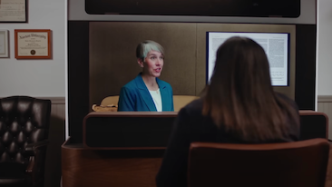 Two people in conversation using Starline. The person on Starline display is speaking, and the back of the head can be seen of the person in the office.